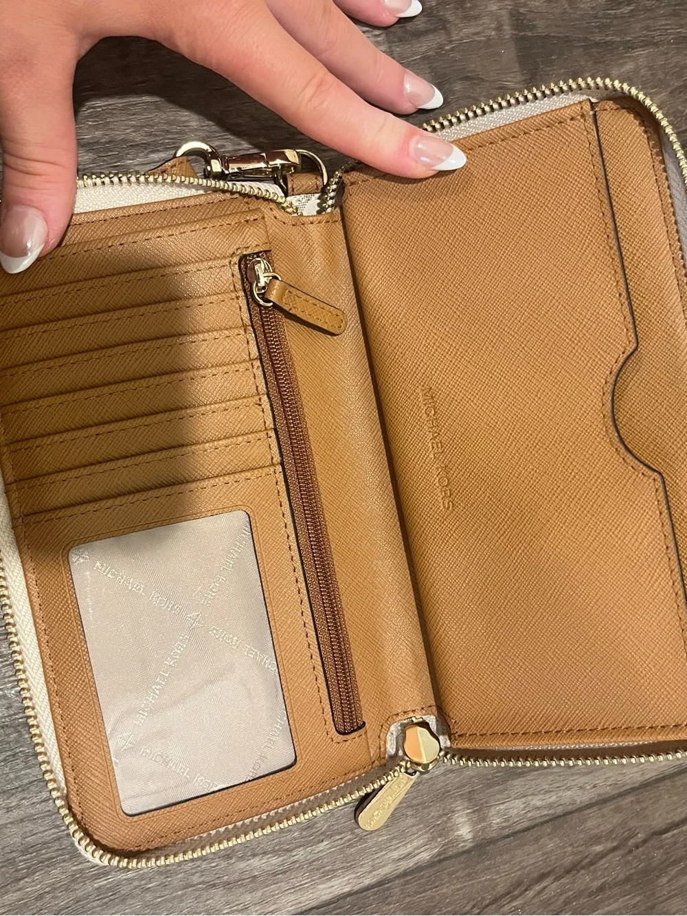 Michael Kors white and tan wallet, pealing on sides shown in photos